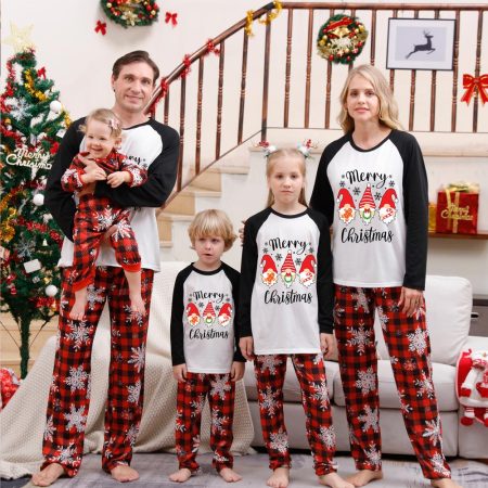 A Happy Family Wearing Christmas Pyjamas With Gonk Print